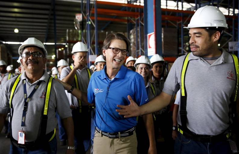 Mendoza, president of Venezuela's largest private food production company Empresas Polar, greats workers after a news conference at a distribution center of the company in Maracay